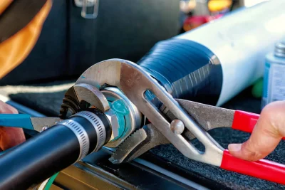 Technician tightening an industrial pipe connection in DeBary