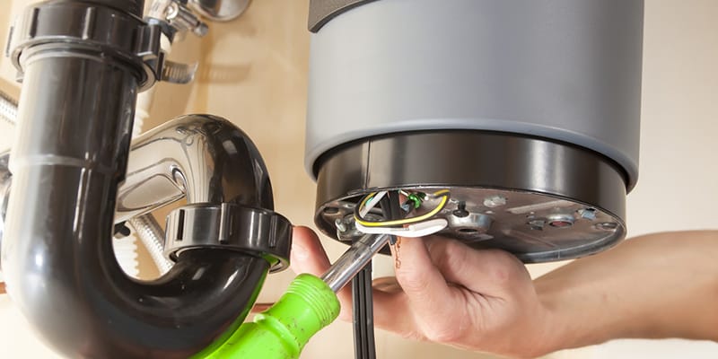 Technician repairing the heating element of a water heater in DeBary