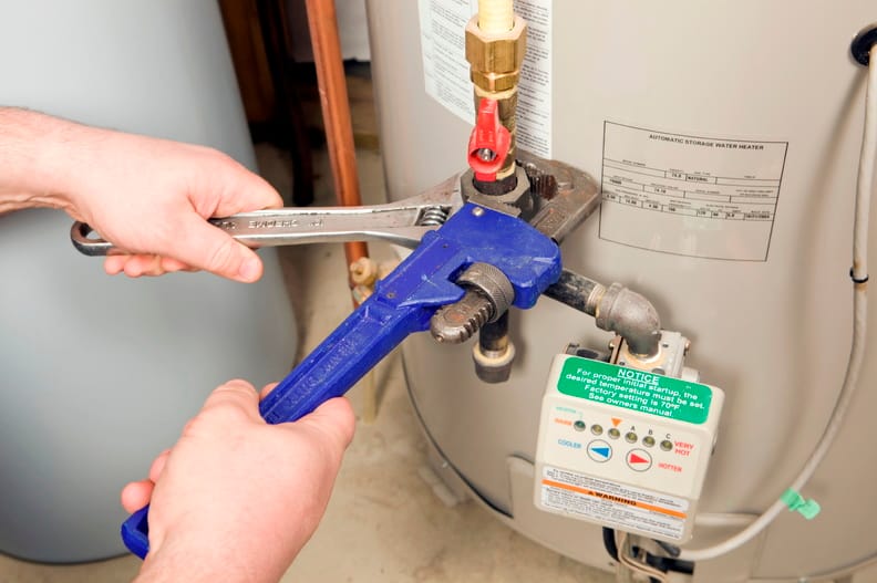Plumber repairing a water heater valve in DeBary